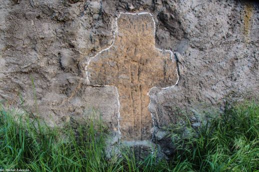 Krzyż pokutny w murze ogrodzenia kościoła, Studnica