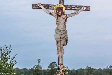 Drewniany krzyż przydrożny z blaszanym Jezusem w Żelaznej